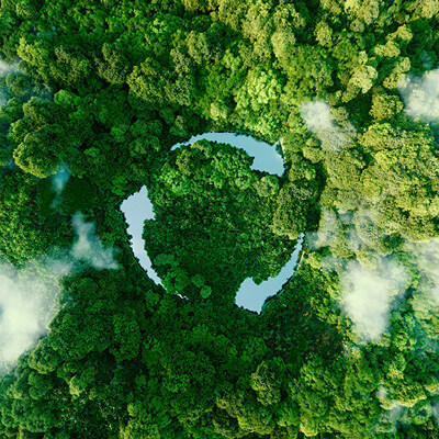 Sustainability banner image-aerial view of tree tops with clouds and the cut out of blue in the shape of continuous arrows indicating recyclability